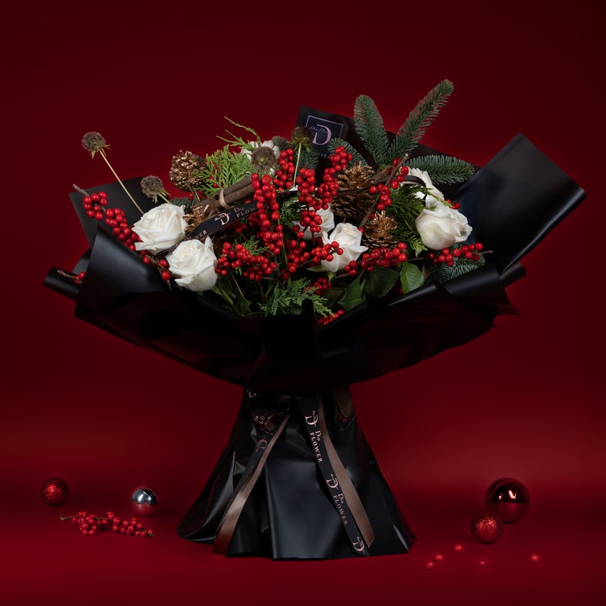 Medium-sized Christmas Sparkle bouquet showcasing a dazzling mix of festive elements and white roses	