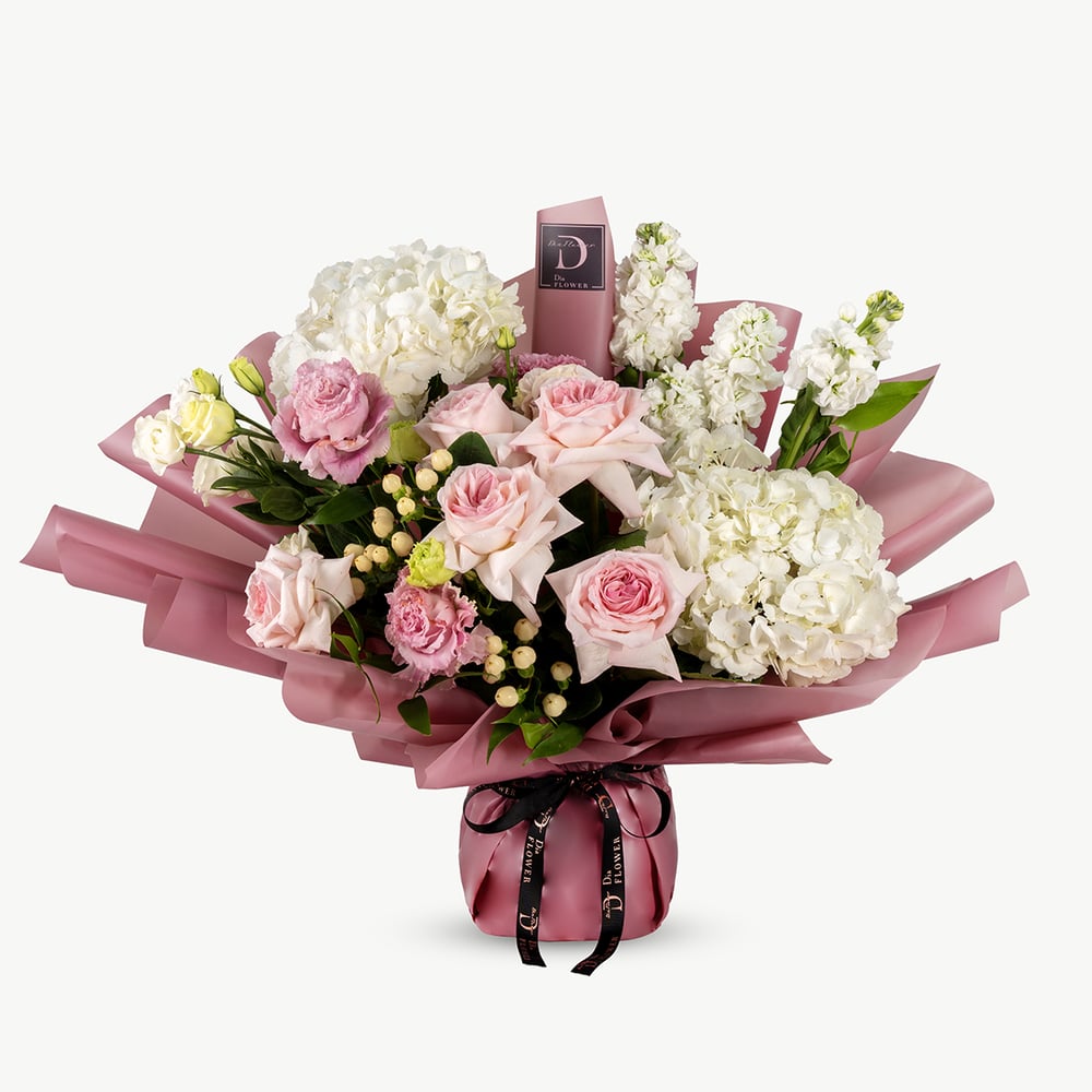 Medium-sized Little Blossoms bouquet showcasing a delicate blend of white and pink flowers	